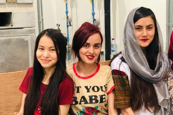 Safa, center, with her friends Tamana, left and Oranous in Doha, Qatar, after being evacuated from Kabul on the weekend.