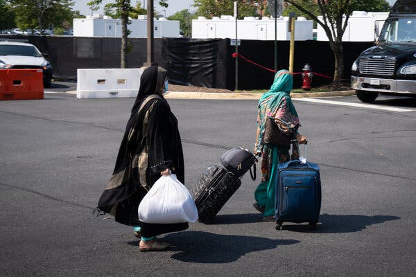 Afghanistan evacuees departing from a processing center at the Dulles Expo Center in Virginia on Thursday.