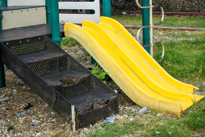 Steps to a slide at the Petion Square playground in Champs-de-Mars, taken on November 17, 2022. The steps where children put their feet have rusted over and decayed. Photo by Marvens Compère for The Haitian Times