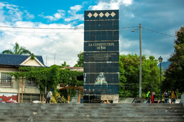 The constitution square is full of dirty old clothes, the bricks are starting to loosen. Graffiti almost covers everything that was written in the monument. Champ de Mars, in Port-au-Prince, Haiti. Photo by Marvens Compère for The Haitian Times