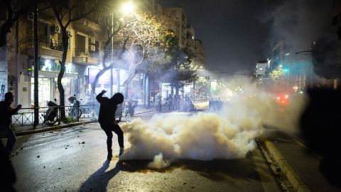 Protesters, pictured on Wednesday, clash with riot police on the streets of Athens, after Tuesday's collision killed dozens and left scores injured.
