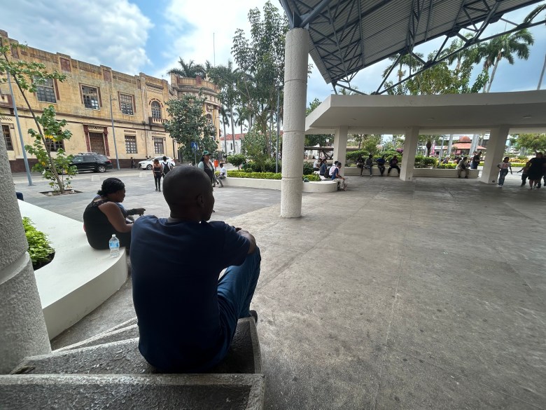 Jean Eubèse Borno, a young Haitian man who had lived in Chile and hoped to enter the U.S. using the CBP One app, is seen in Parque Central Miguel Hidalgo. Photo by Annika Hom for The Haitian Times.