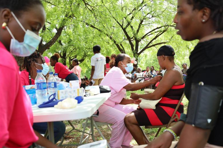 Patients having their vital signs checked before seeing a doctor during the mobile clinic organized by the Haitian Midwives Association (ASFH) at the Quiskeya Chapel in Delmas 75, on Saturday, May 3, 2025. Photo by Dieugo André for The Haitian Times.
