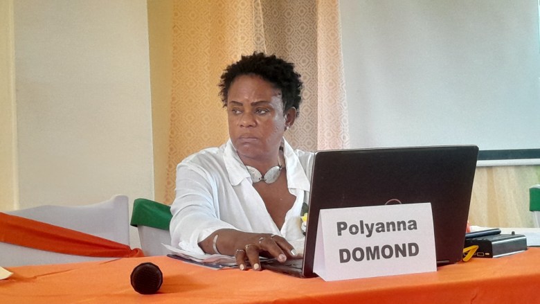 Polyanna Domond, deputy director of the defense force of the Southeast Department, talking about the gang violence crisis during the Patriotic Congress for National Rescue, this Friday, June 13, 2025, at the UPSEJ Faculty of Education. Photo by Danise Davide Lejustal for The Haitian Times. 