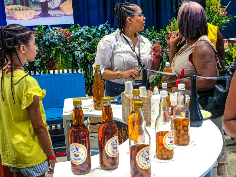 Bottles infused with alcohol and flavored with tamarind, quenepa, or cherry from Les Délices de Vida were showcased to visitors at the first edition of the HAIFEX Women’s Entrepreneurship Fair, held in Pétion-Ville on July 6, 2025. Photo by Juhakenson Blaise/The Haitian Times.