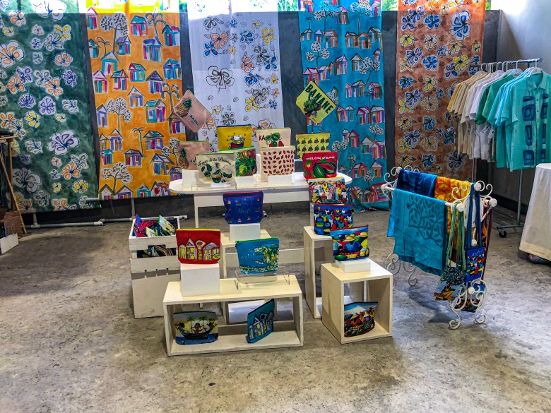 Small handmade carry-on bags featuring illustrations of Haitian sailboats, rural houses, and Madan Sara women were on display at the first edition of the HAIFEX Women’s Entrepreneurship Fair, held in Pétion-Ville on July 6 and 7, 2025. Photo by Juhakenson Blaise/The Haitian Times
