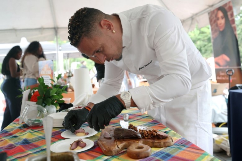 Chef Antoine Zulemaro of French Guiana prepares smoked duck breast with parepou cream, brown butter, corn tempura, smoked paprika and duck jus with ginger confit at the Creole Food Festival in Brooklyn on Saturday, Sept. 27, 2025. The festival was held at Emily Roebling Plaza under the Brooklyn Bridge. Photo by Bill Farrington.
