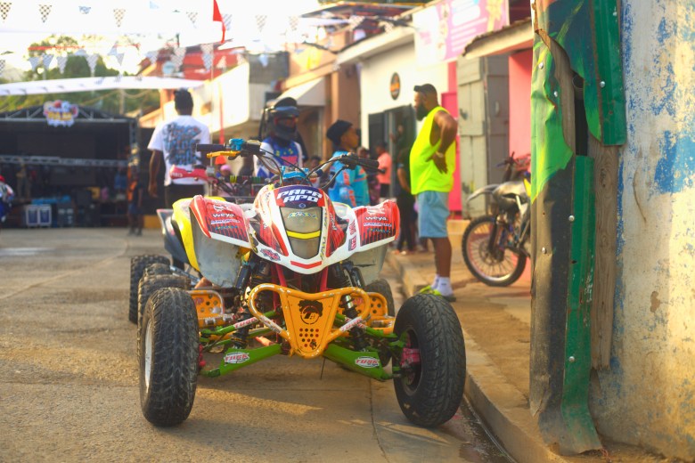 A four-wheeler sits parked on the roadside before the start of the Ruff Ryders Block Party on March 7, 2026, in Cap-Haïtien. Photo by Onz Chéry / The Haitian Times.
