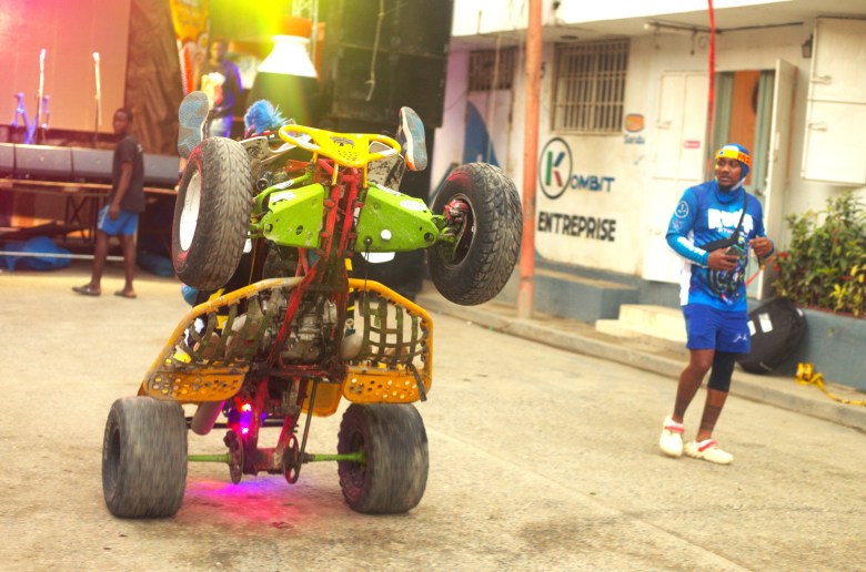 The underside of a four-wheeler is visible during a wheelie at the third edition of the Ruff Ryders Block Party on March 7, 2026, in Cap-Haïtien. Photo by Onz Chéry / The Haitian Times.
