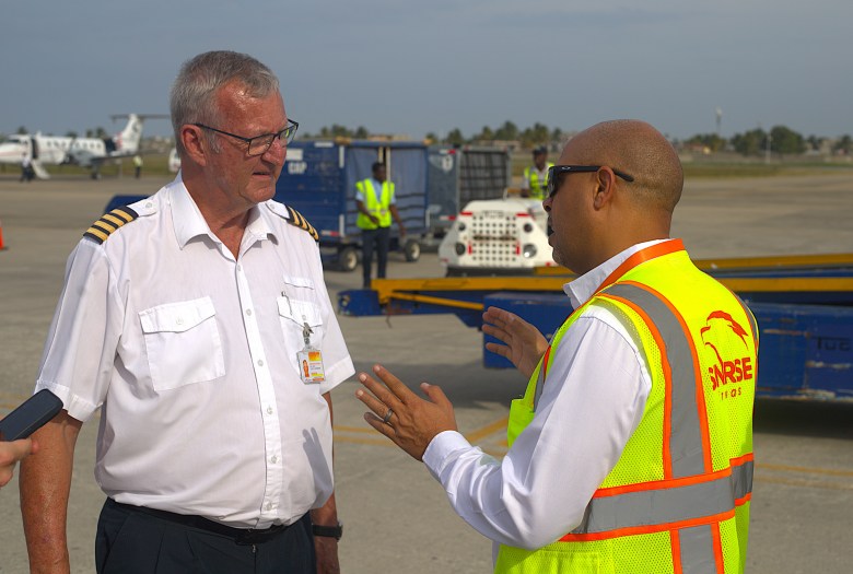 A pilot speaks with a Sunrise Airways employee before departure. Photo by Onz Chéry/The Haitian Times.
