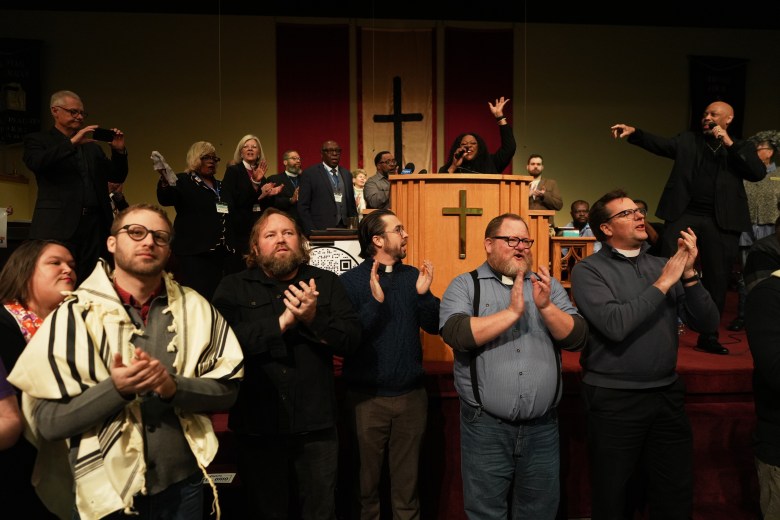 Faith leaders from across the United States sing together as a sign of support for Haitian migrants fearing the end of their Temporary Protected Status in the U.S., at an event held at St. John Missionary Baptist Church in Springfield, Ohio, on Monday, Feb. 2, 2026. (AP Photo/Luis Andres Henao)
