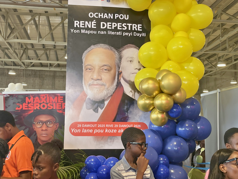 The 32nd edition of Livres en Folie displays a banner that pays tribute to the renowned writer René Depestre, at the El Rancho Hotel in Pétion-Ville on Thursday, June 4, 2026. Photo by Juhakenson Blaise / The Haitian Times