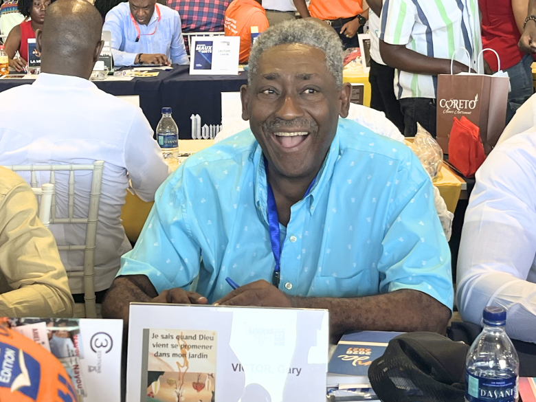 Haitian writer Gary Victor overjoyed at the 32nd edition of Livres en Folie at the El Rancho Hotel in Pétion-Ville on Thursday, June 4, 2026. Photo by Juhakenson Blaise / The Haitian Times
