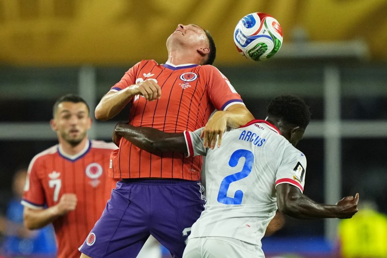 Haiti's Carlens Arcus (2) and Scotland's Lawrence Shankland (20) compete to head the ball during the World Cup Group C soccer match between Haiti and Scotland in Foxborough, Mass., near Boston, Saturday, June 13, 2026. (AP Photo/Martin Meissner)