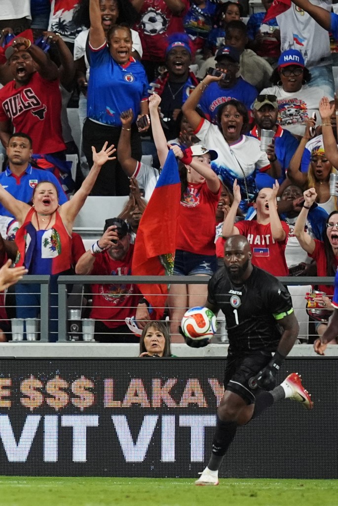 Haiti fans cheer as goalkeeper Johnny Placide (1) clears a ball after stopping a scoring attempt by Peru during the second half of an international friendly soccer match, Friday, June 5, 2026, in Miami. (AP Photo/Rebecca Blackwell)