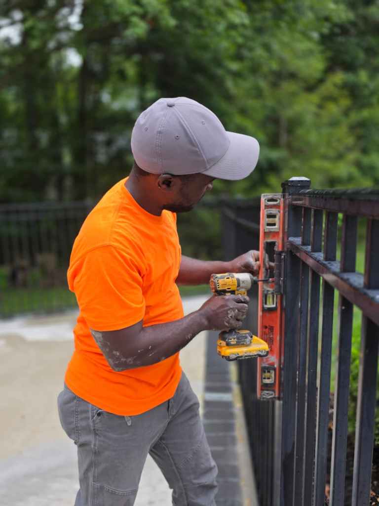 Vaillant fixing a back patio fence for a home owner in Columbus, Ohio on Wednesday, August 12, 2026. Photo by Rupal R. Shah for The Haitian Times.