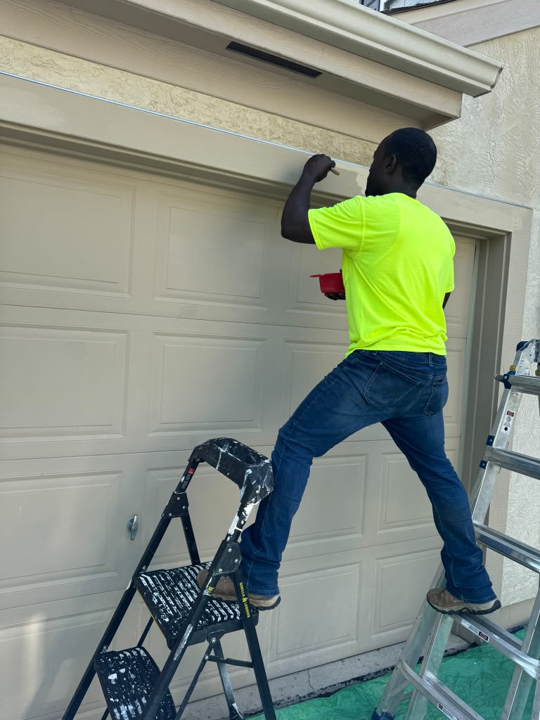 Vaillant, owner of Z-Remodeling & Hardscaping, adding the final touches to the exterior of a resident’s garage that was fixed by his employees, in July 2024. Photo by Z-Remodeling & Hardscaping