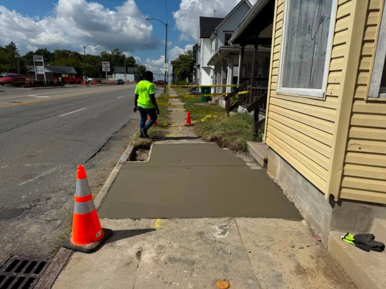 Employees of Z-Remodeling & Hardscaping reviewing poured concrete as it dries at the front of a resident’s home in July, 2025. Photo by Z-Remodeling & Hardscaping