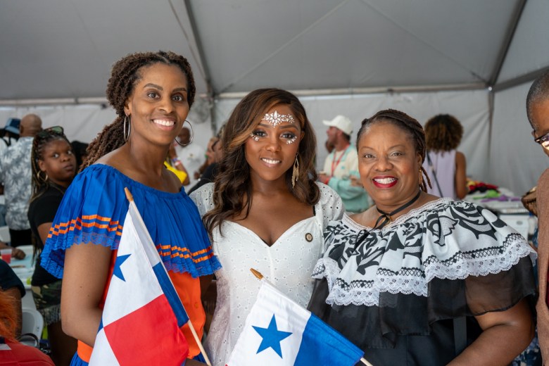 Councilmember Farah Louis (center) poses with two attendees holding Panamanian flags during WIADCA’s 59th annual VIP Breakfast in Brooklyn on Sept. 7, 2026. The event brought together representatives and supporters of Caribbean communities ahead of the annual parade. Photo by Fredner Caimite/The Haitian Times.